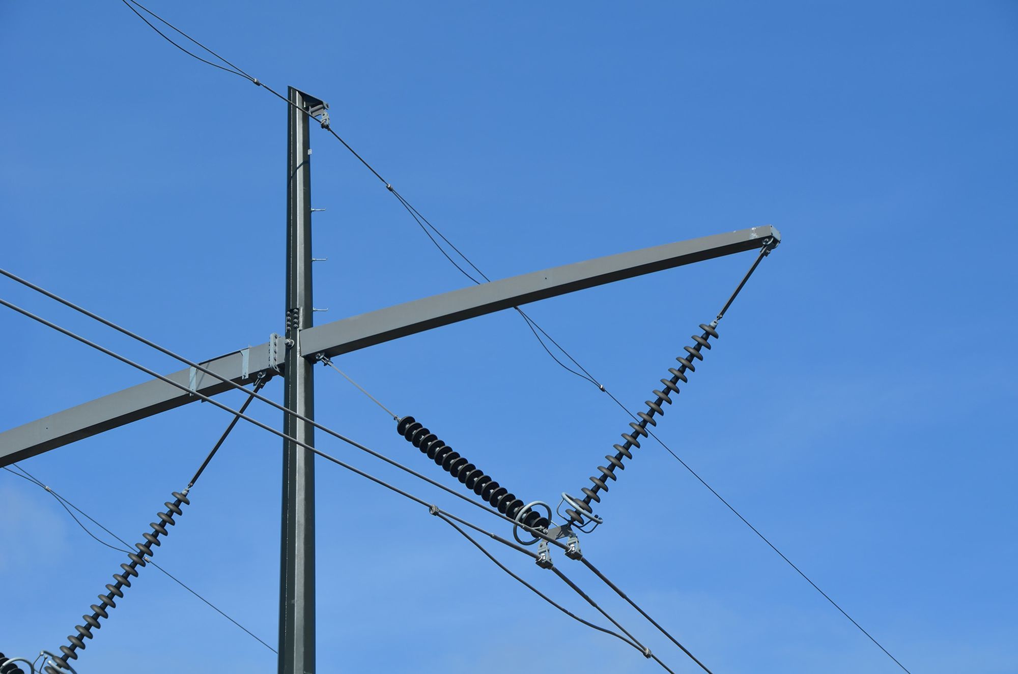 Close up shot of a transmission tower with clear blue sky in the background