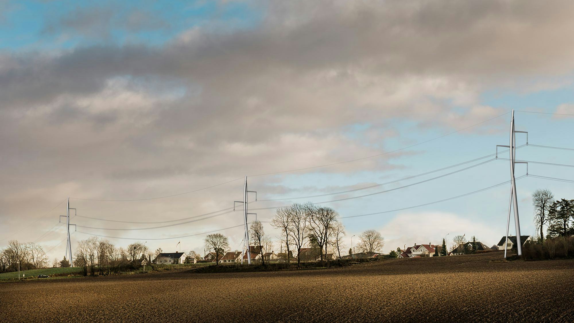 Houses aligned with transmission towers in the foreground