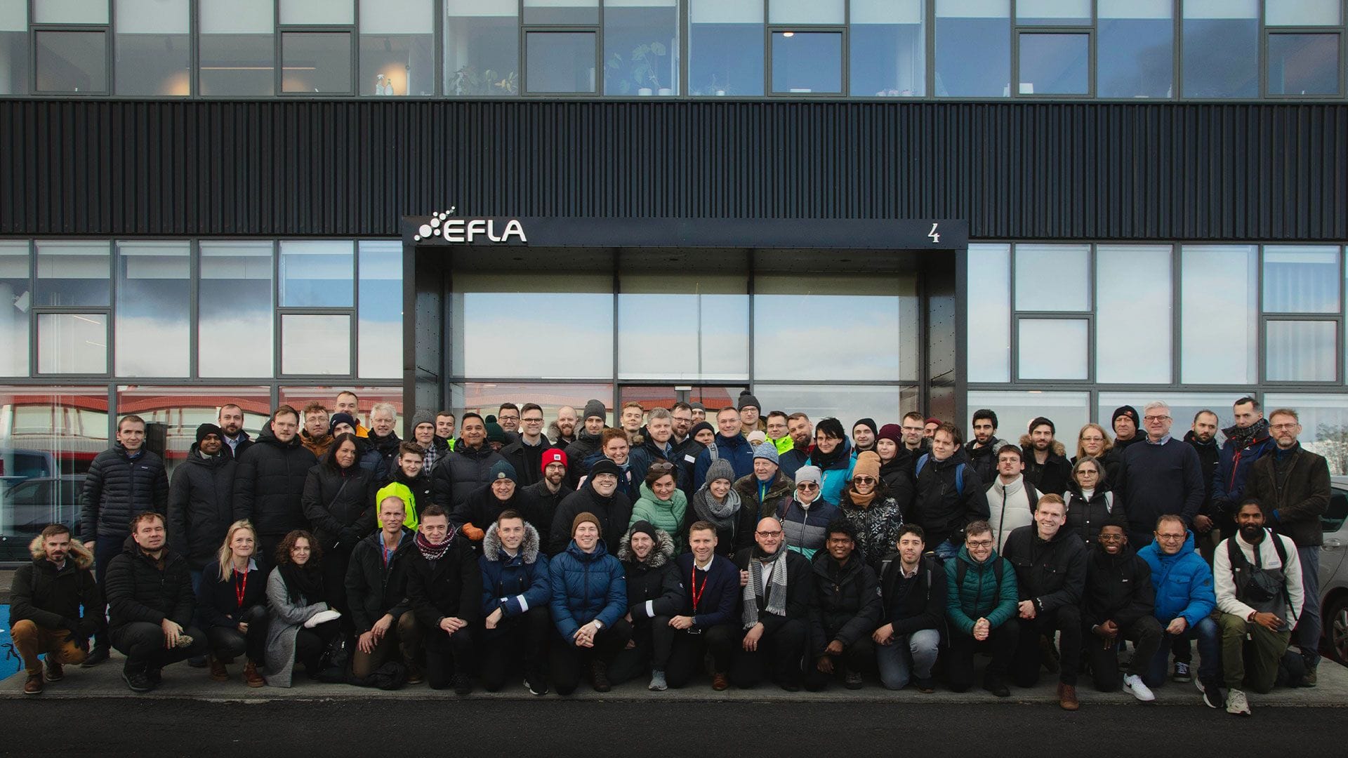 Group of people standing in front of a building.