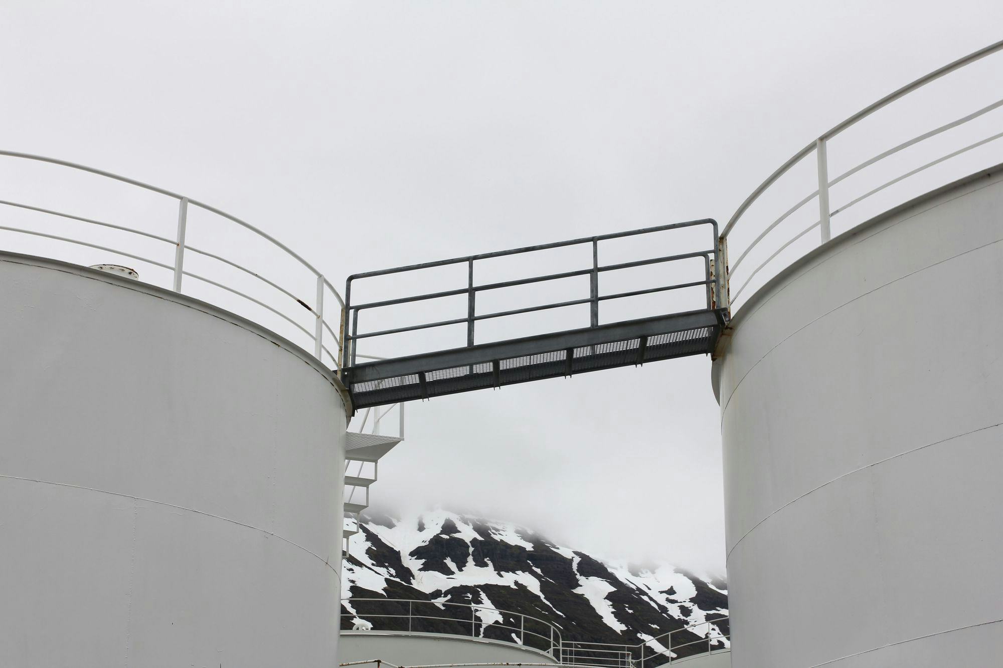 A factory on the quay, snow-capped mountains in the background