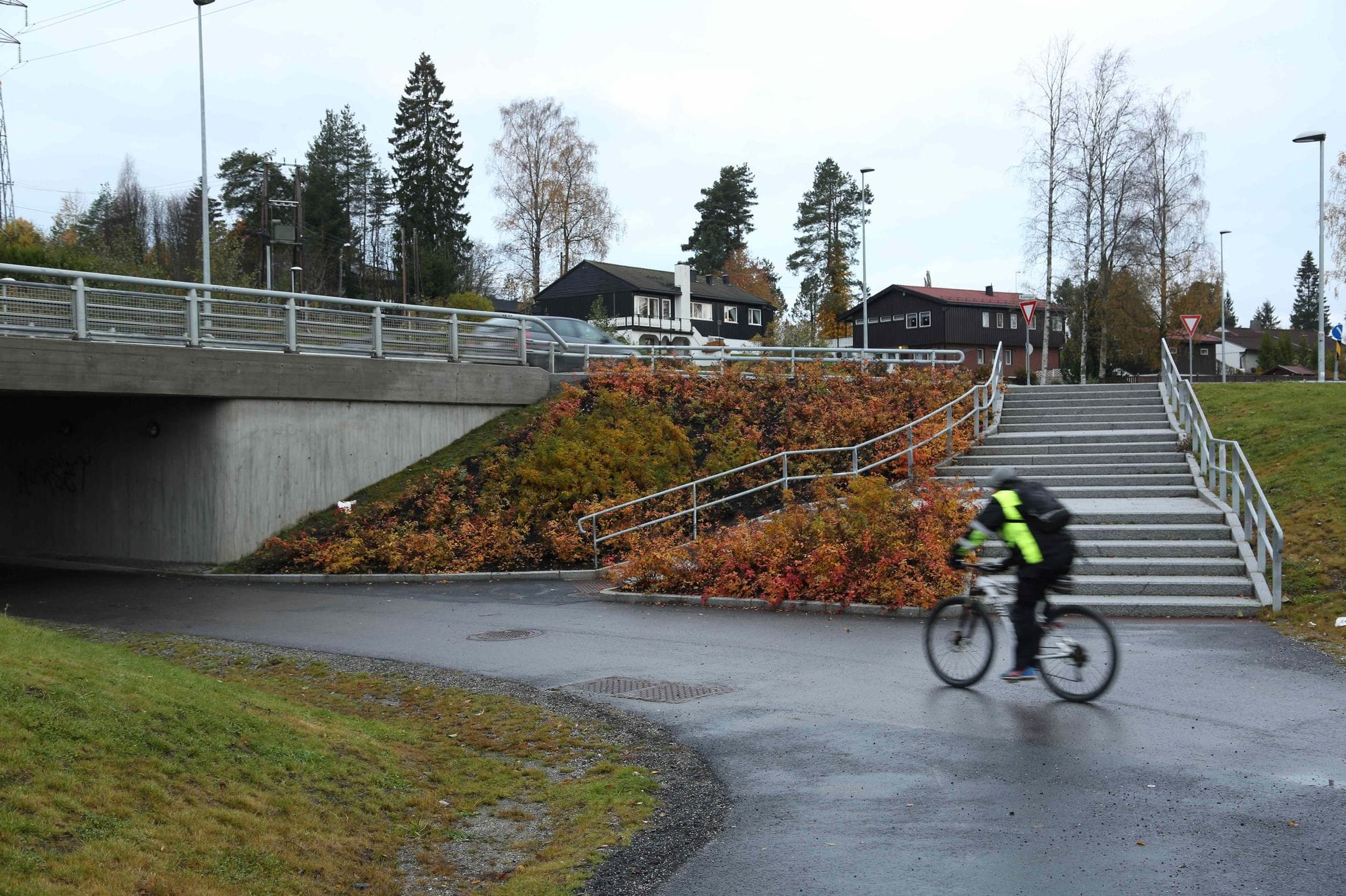 A man cycling into tunnels surrounded by landscaped environment