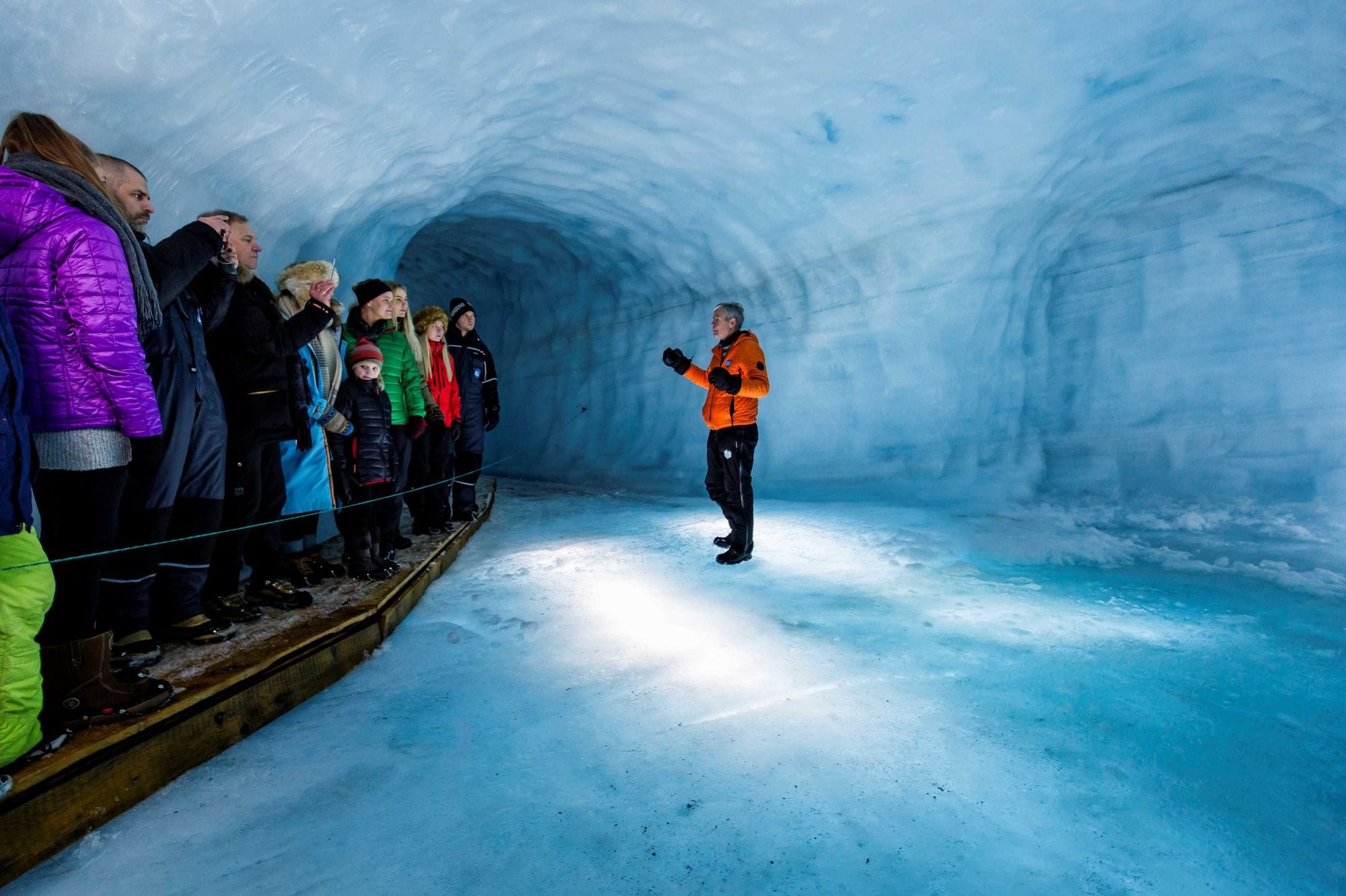 A guide giving a tour within an ice cave