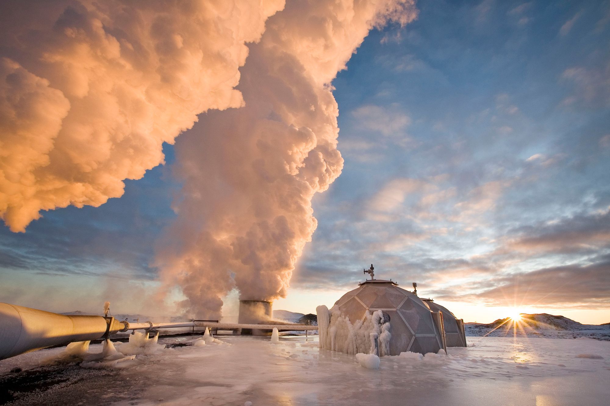 Smoke rising from pipes next to frozen igloo