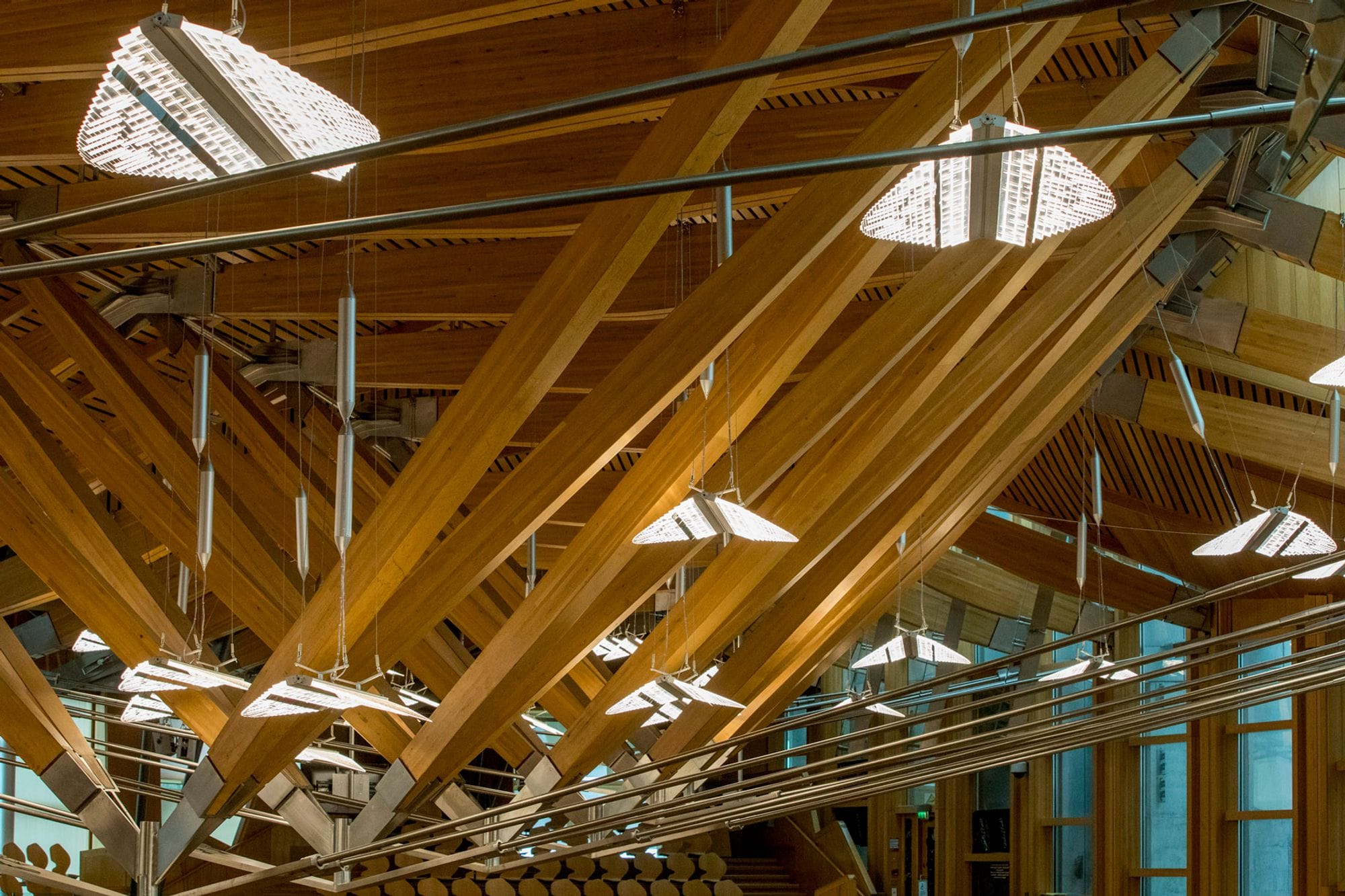 wood lattice ceiling with chandeliers that look like leaves or something floating